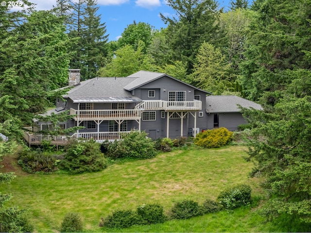 21075 NE Turner Ln, Hillsboro, OR 97123 - rear view of property with a deck, a chimney, a yard, and roof with shingles