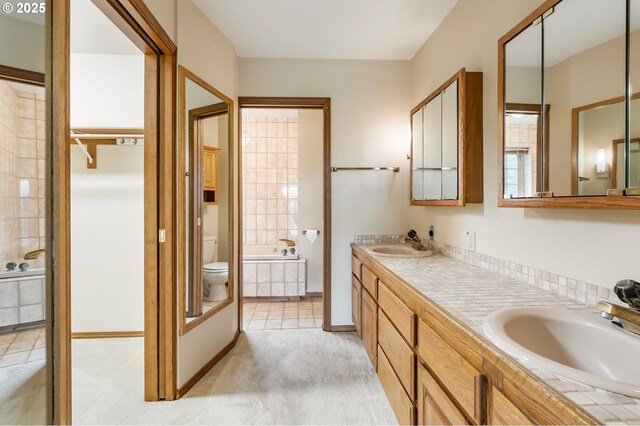 21075 NE Turner Ln, Hillsboro, OR 97123 - bathroom with a garden tub, toilet, double vanity, and tile patterned flooring
