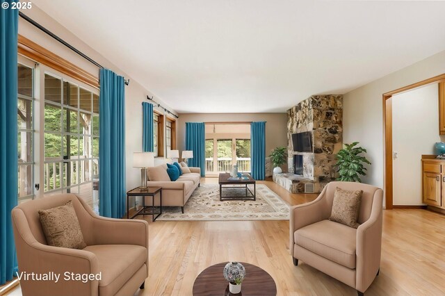 21075 NE Turner Ln, Hillsboro, OR 97123 - living area featuring light wood-type flooring and a fireplace