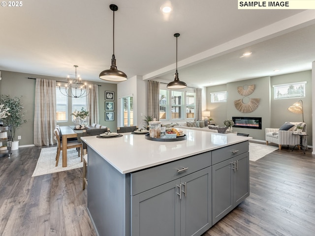 kitchen with dark wood-type flooring, open floor plan, light countertops, and gray cabinets