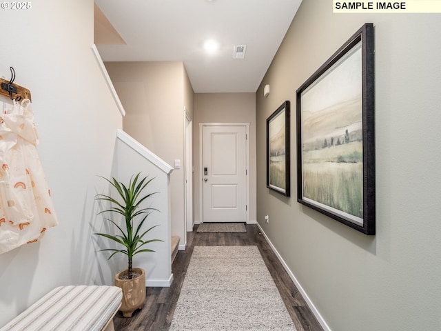 hall with baseboards, dark wood-style floors, and stairs