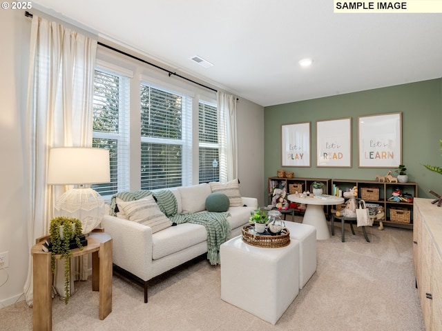 living room with visible vents and light carpet