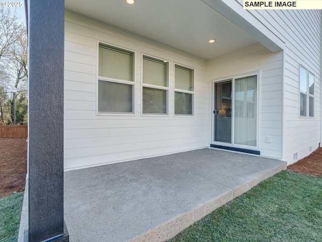 doorway to property featuring a patio area, crawl space, and fence