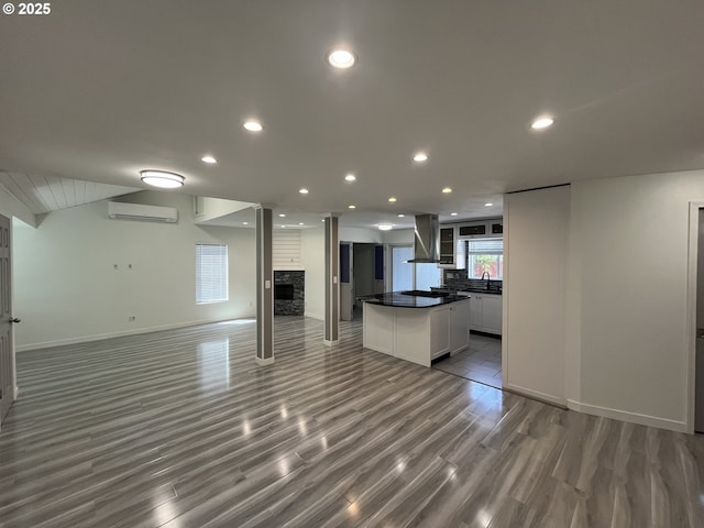 3345 SW 124th Ave, Beaverton, OR 97005 - unfurnished living room featuring an AC wall unit, a fireplace, wood finished floors, and recessed lighting