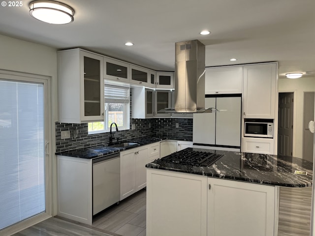 3345 SW 124th Ave, Beaverton, OR 97005 - kitchen featuring island range hood, white appliances, tasteful backsplash, dark stone countertops, and white cabinetry