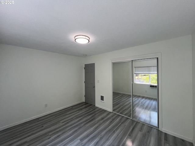 3345 SW 124th Ave, Beaverton, OR 97005 - unfurnished bedroom featuring dark wood-style flooring, a closet, and a textured ceiling