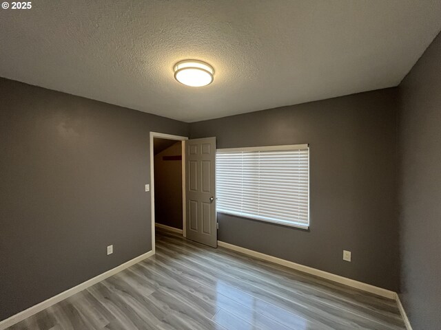 3345 SW 124th Ave, Beaverton, OR 97005 - unfurnished room with wood finished floors and a textured ceiling