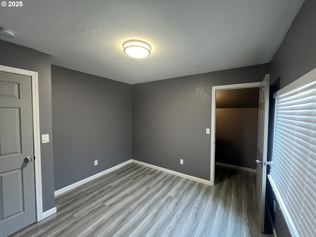 3345 SW 124th Ave, Beaverton, OR 97005 - spare room featuring wood finished floors, a textured ceiling, and a smoke detector