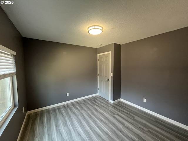3345 SW 124th Ave, Beaverton, OR 97005 - empty room featuring wood finished floors, healthy amount of natural light, and a textured ceiling