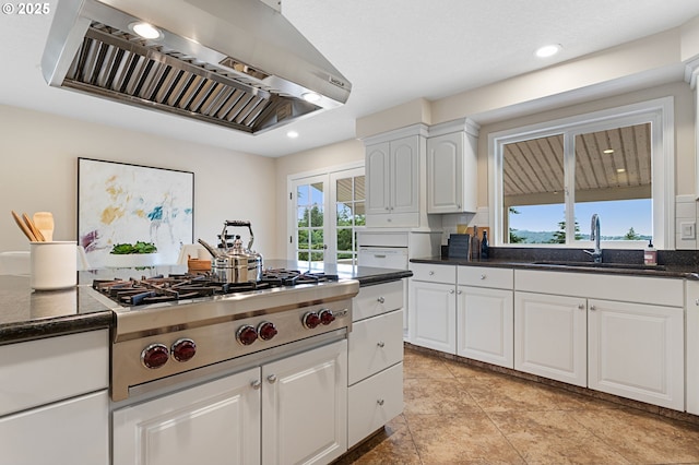 3025 SW Wallula Ave, Gresham, OR 97080 - kitchen with wall chimney range hood, white cabinets, stainless steel gas stovetop, recessed lighting, and light tile patterned floors
