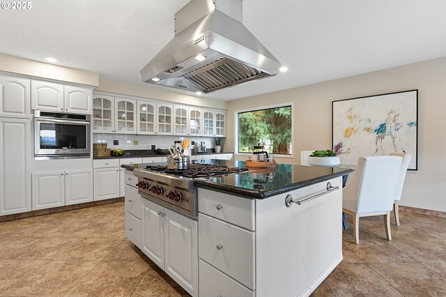 3025 SW Wallula Ave, Gresham, OR 97080 - kitchen with island range hood, stainless steel appliances, white cabinets, a center island, and glass insert cabinets