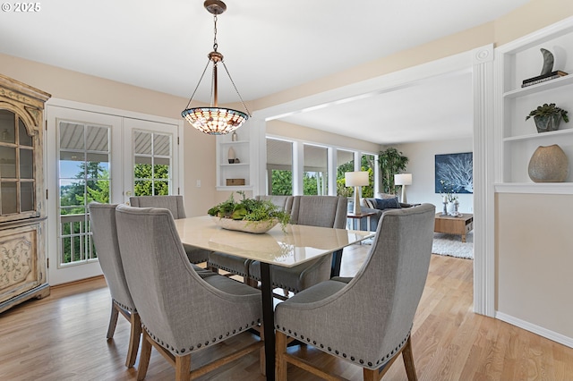 3025 SW Wallula Ave, Gresham, OR 97080 - dining space featuring french doors, built in shelves, and light wood-style floors