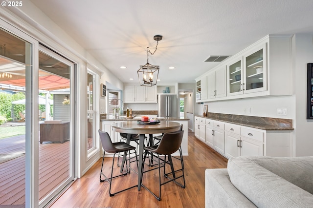 13355 SW Chimney Ridge Ct, Tigard, OR 97223 - dining area featuring light wood-style floors, recessed lighting, and a chandelier