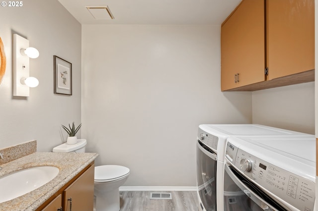 13355 SW Chimney Ridge Ct, Tigard, OR 97223 - bathroom featuring washing machine and dryer, vanity, and wood finished floors