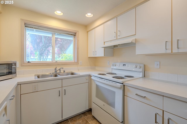 kitchen with stainless steel microwave, a sink, light countertops, under cabinet range hood, and white range with electric cooktop