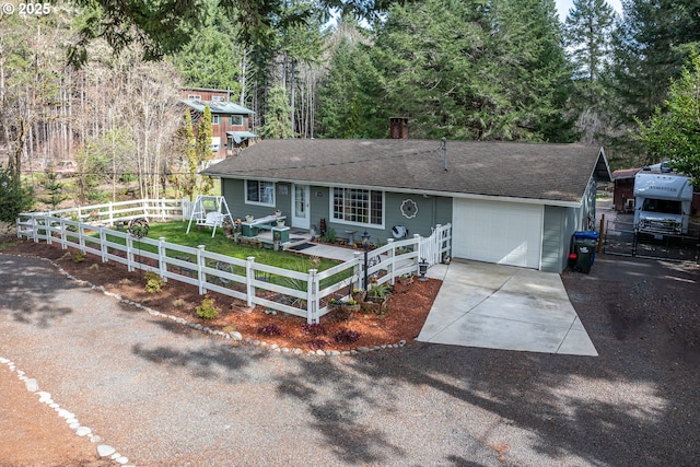 single story home with a fenced front yard, a chimney, a shingled roof, a garage, and driveway