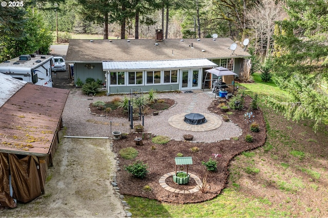 rear view of house featuring an outdoor fire pit, a chimney, french doors, and a patio