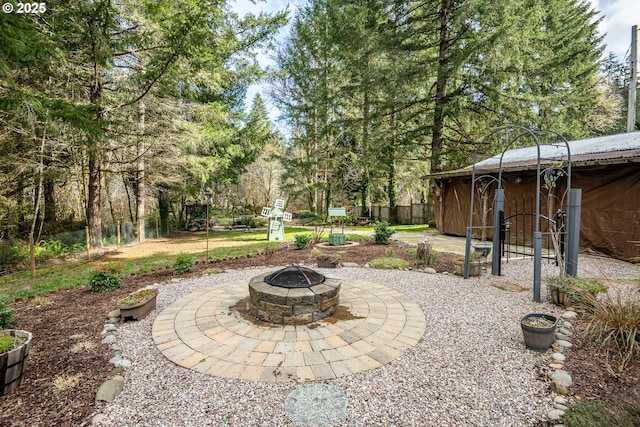 view of patio / terrace featuring a fire pit and fence