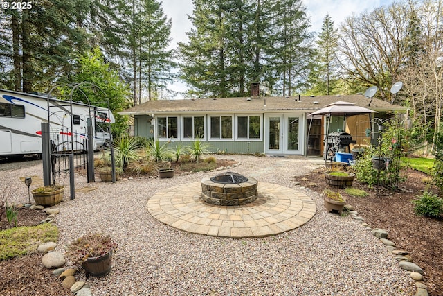 back of property with french doors and a fire pit