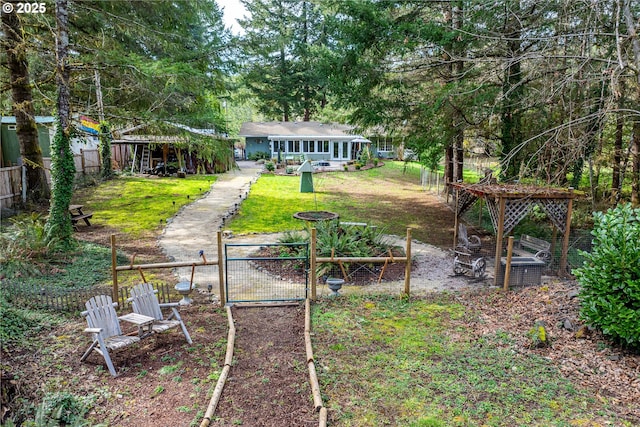 view of yard featuring a gate, a garden, and fence