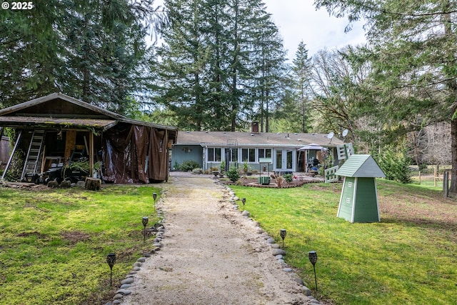 single story home featuring dirt driveway and a front yard