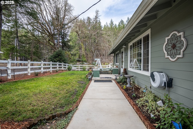 view of yard featuring central AC and fence