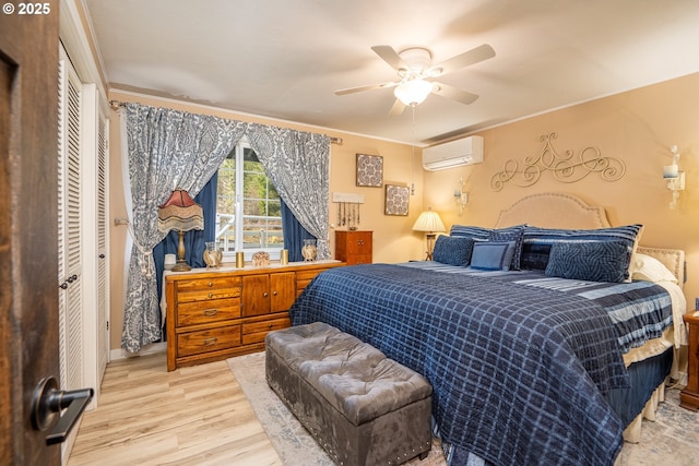 bedroom featuring a ceiling fan, a wall unit AC, crown molding, and wood finished floors