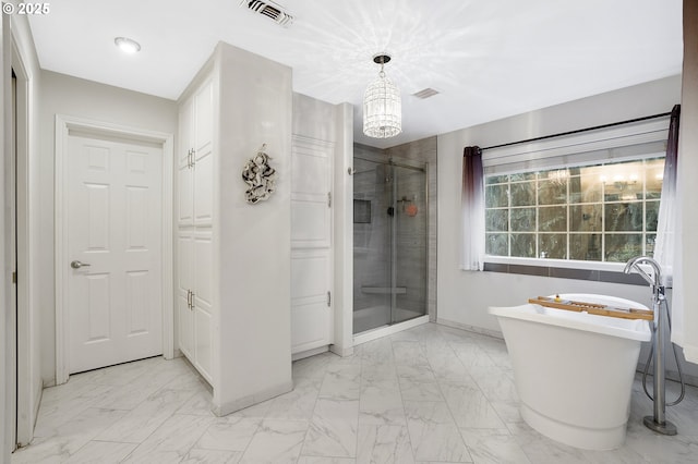 bathroom featuring independent shower and bath and a notable chandelier