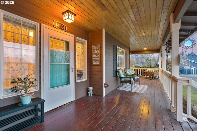 wooden terrace featuring covered porch