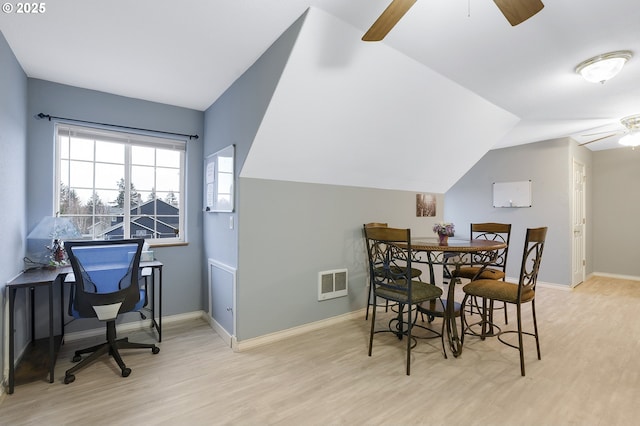 dining area featuring vaulted ceiling, light hardwood / wood-style floors, and ceiling fan