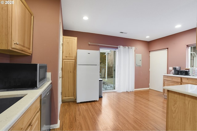 kitchen with appliances with stainless steel finishes, sink, light hardwood / wood-style flooring, and light brown cabinets