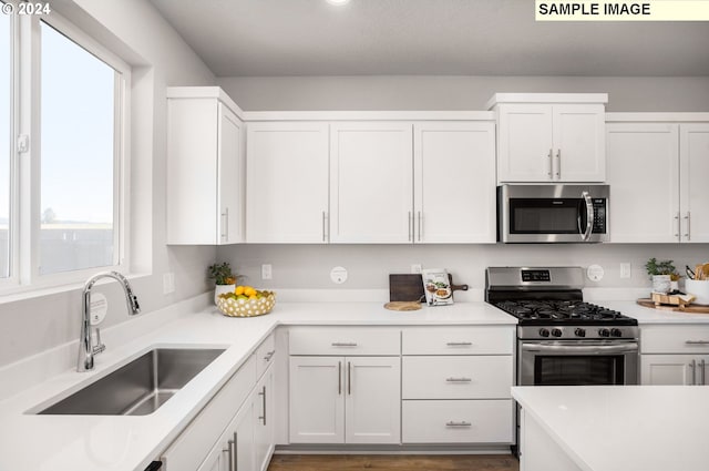 4321 Dogwood Ave, Albany, OR 97322 - kitchen with stainless steel appliances, a sink, and white cabinets