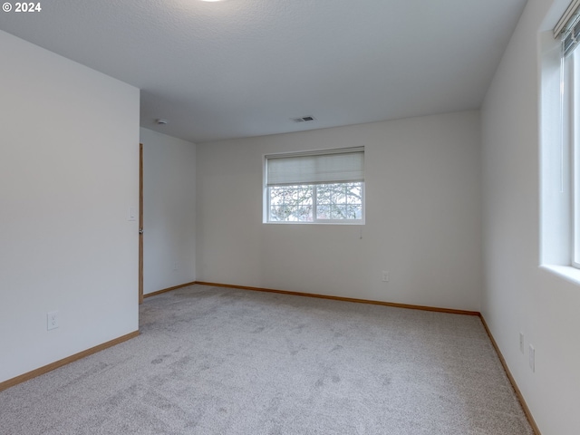 empty room featuring light carpet