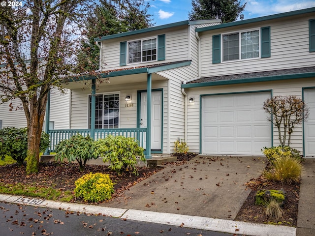 view of front property featuring a garage and covered porch