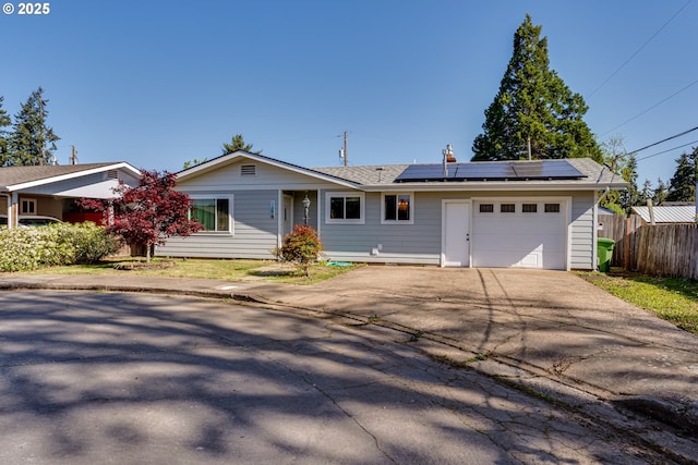 1080 E Jackson Ave, Cottage Grove, OR 97424 - single story home featuring a garage, fence, driveway, and solar panels