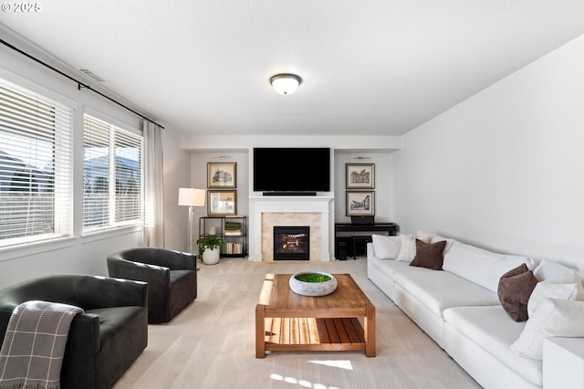 carpeted living room with a tiled fireplace