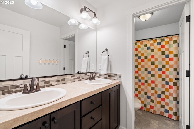 bathroom featuring toilet, a shower with shower curtain, vanity, and decorative backsplash