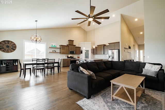 5300 Davis St SE, Turner, OR 97392 - living area featuring ceiling fan, high vaulted ceiling, wood finished floors, and a chandelier