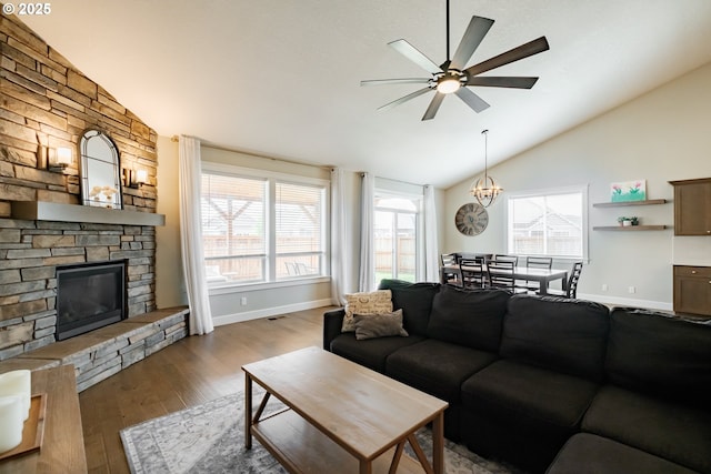 5300 Davis St SE, Turner, OR 97392 - living room with a ceiling fan, a stone fireplace, wood finished floors, high vaulted ceiling, and a chandelier