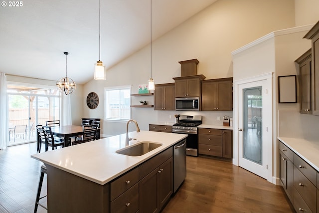 5300 Davis St SE, Turner, OR 97392 - kitchen featuring appliances with stainless steel finishes, high vaulted ceiling, dark brown cabinets, dark wood finished floors, and light countertops