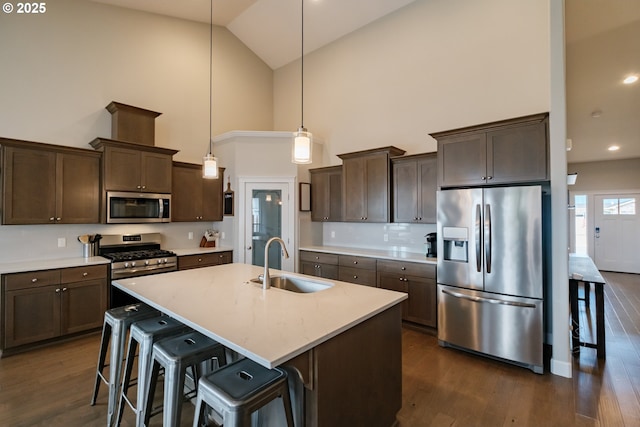 5300 Davis St SE, Turner, OR 97392 - kitchen featuring stainless steel appliances, high vaulted ceiling, dark wood-style floors, dark brown cabinetry, and light countertops