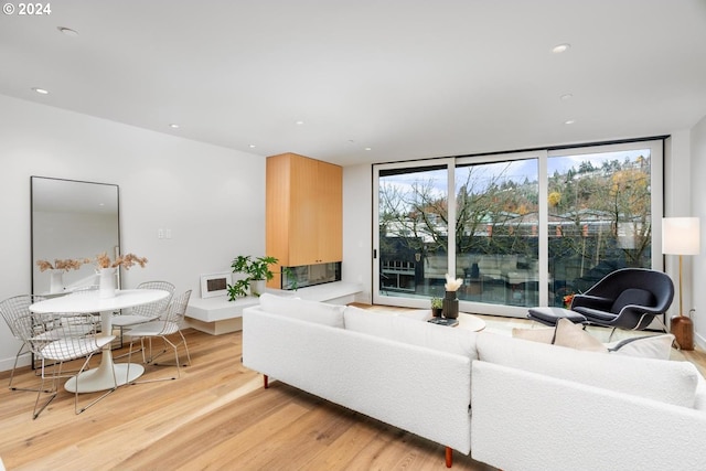 2795 NW Thurman St, Portland, OR 97210 - living room with expansive windows, light wood-style floors, and recessed lighting