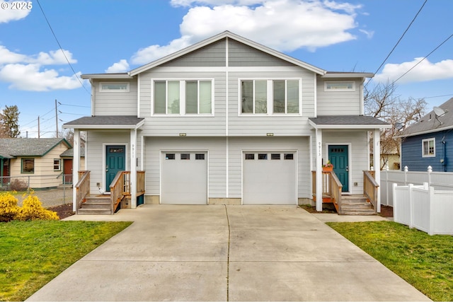 view of front of property featuring a garage, concrete driveway, a front yard, and fence