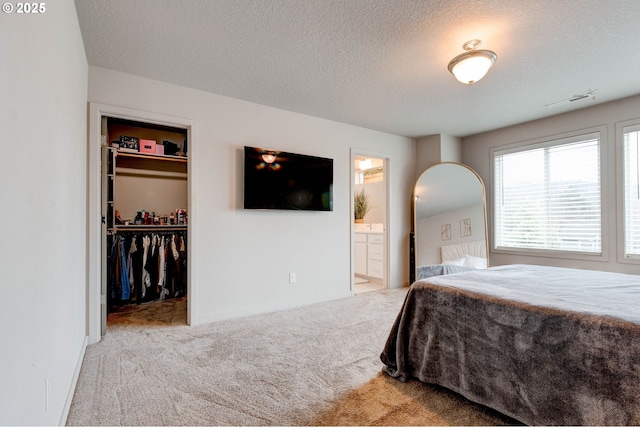 9911 SE Duke St, Portland, OR 97266 - bedroom featuring carpet, a closet, a spacious closet, connected bathroom, and a textured ceiling