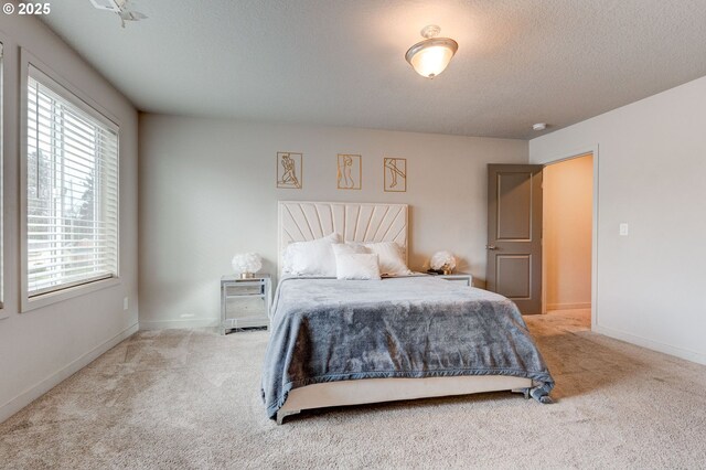 9911 SE Duke St, Portland, OR 97266 - carpeted bedroom with a textured ceiling and baseboards
