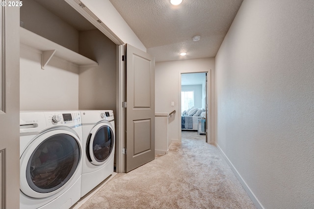 9911 SE Duke St, Portland, OR 97266 - laundry room with a textured ceiling, washing machine and dryer, light carpet, laundry area, and baseboards