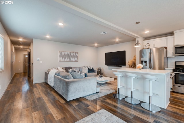 9911 SE Duke St, Portland, OR 97266 - living area featuring recessed lighting, visible vents, dark wood finished floors, and baseboards