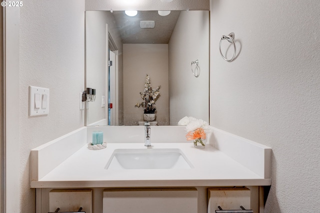 9911 SE Duke St, Portland, OR 97266 - bathroom with vanity and a textured wall