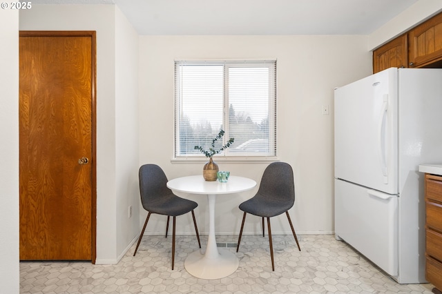 dining space with baseboards