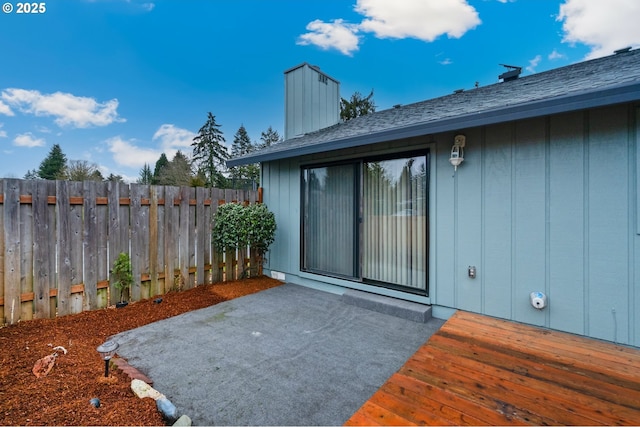 view of patio / terrace with a wooden deck and fence